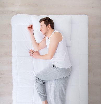 A man sleeping on a quality timber Galligan bed